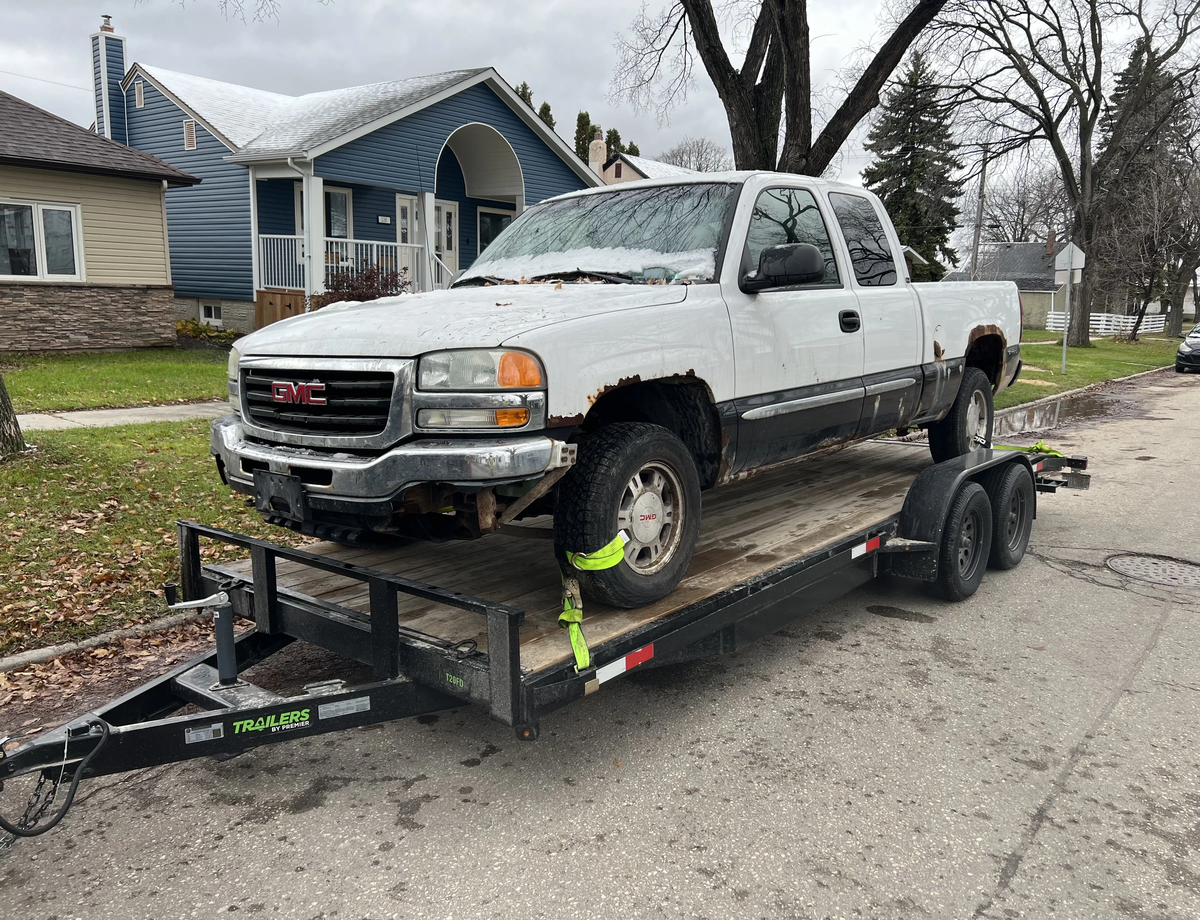 White GMC truck on trailer