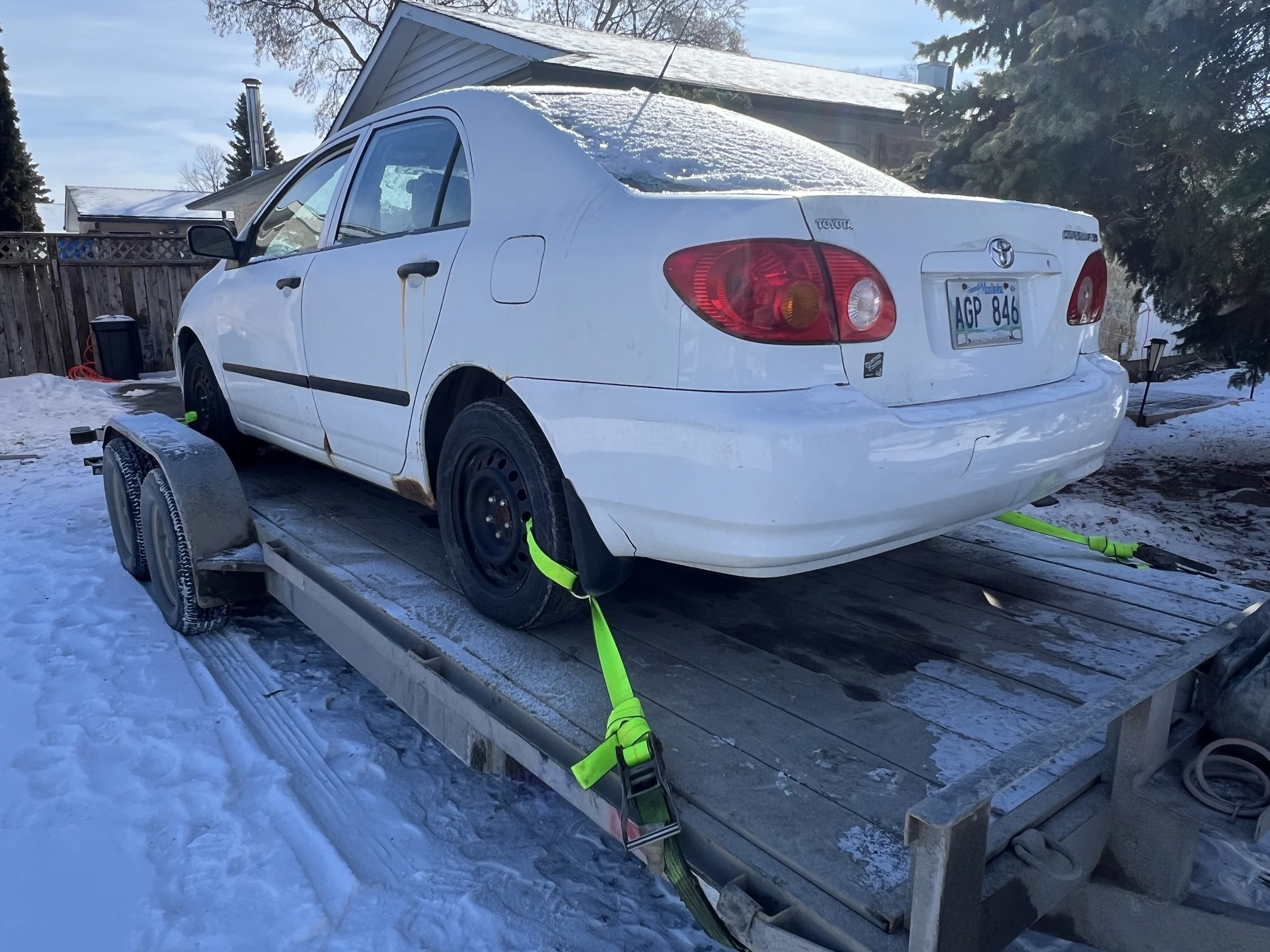White Car on Trailer in Snow
