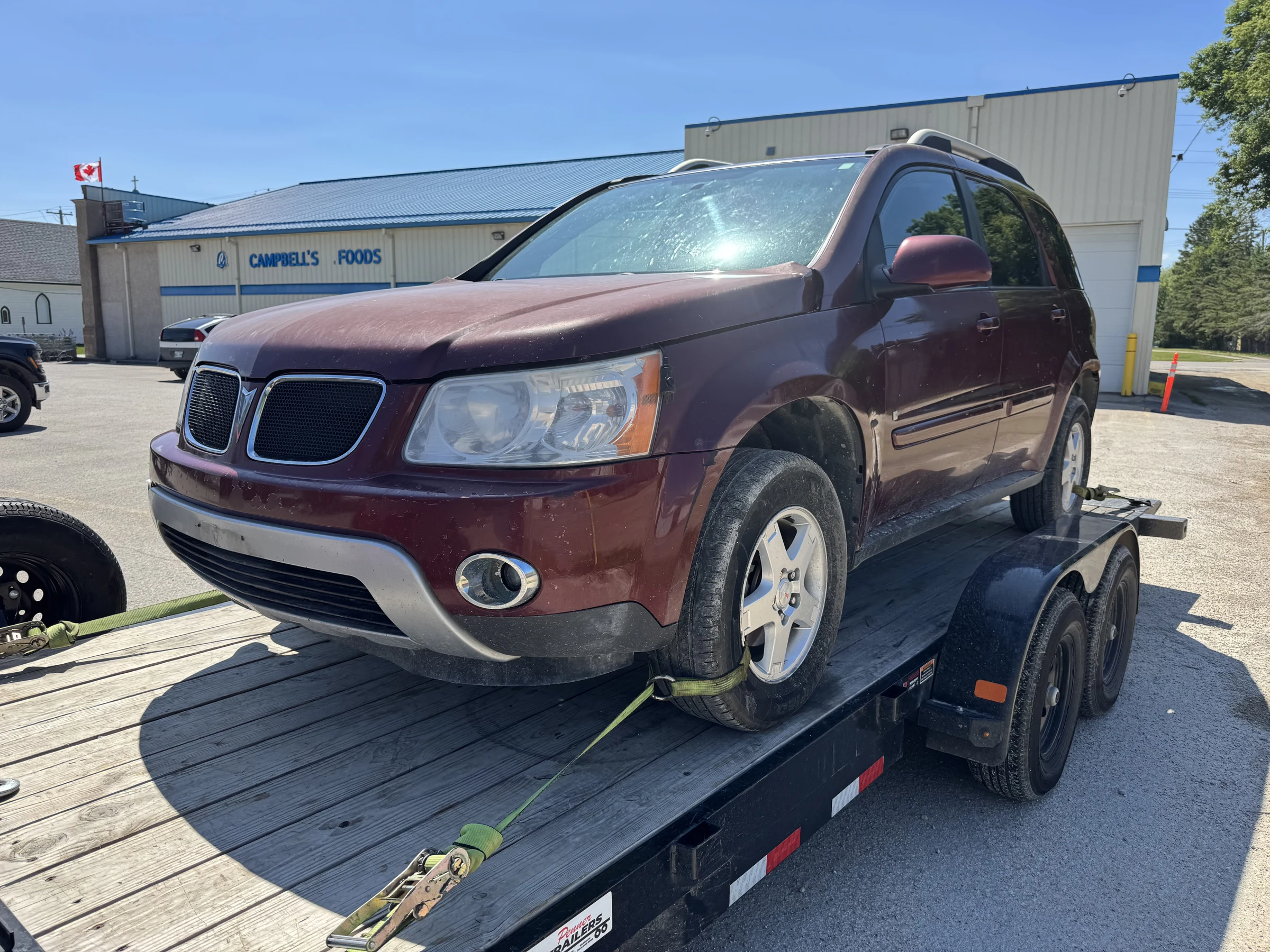 Maroon SUV on Flatbed Trailer
