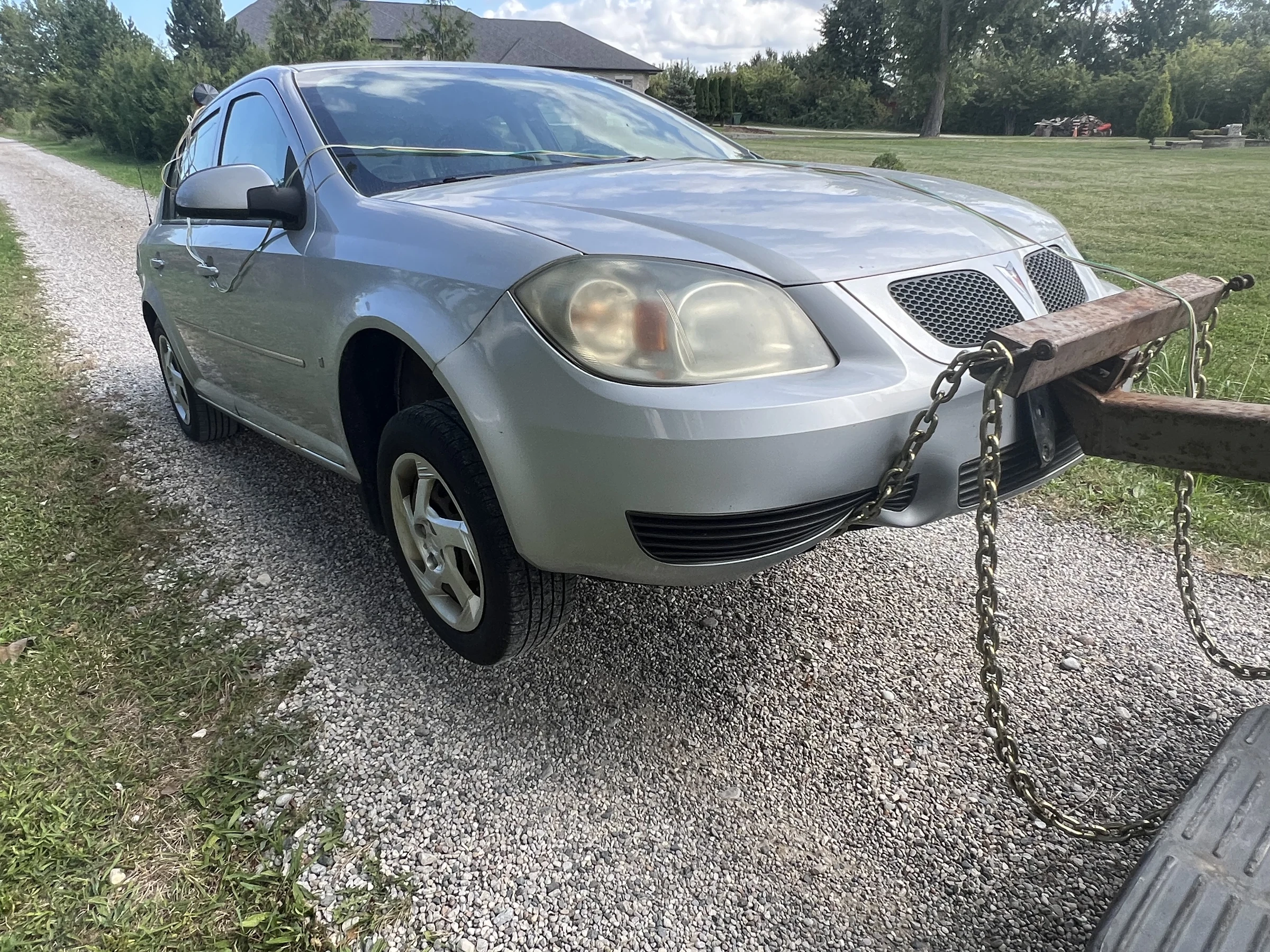 Silver Compact Car on Gravel